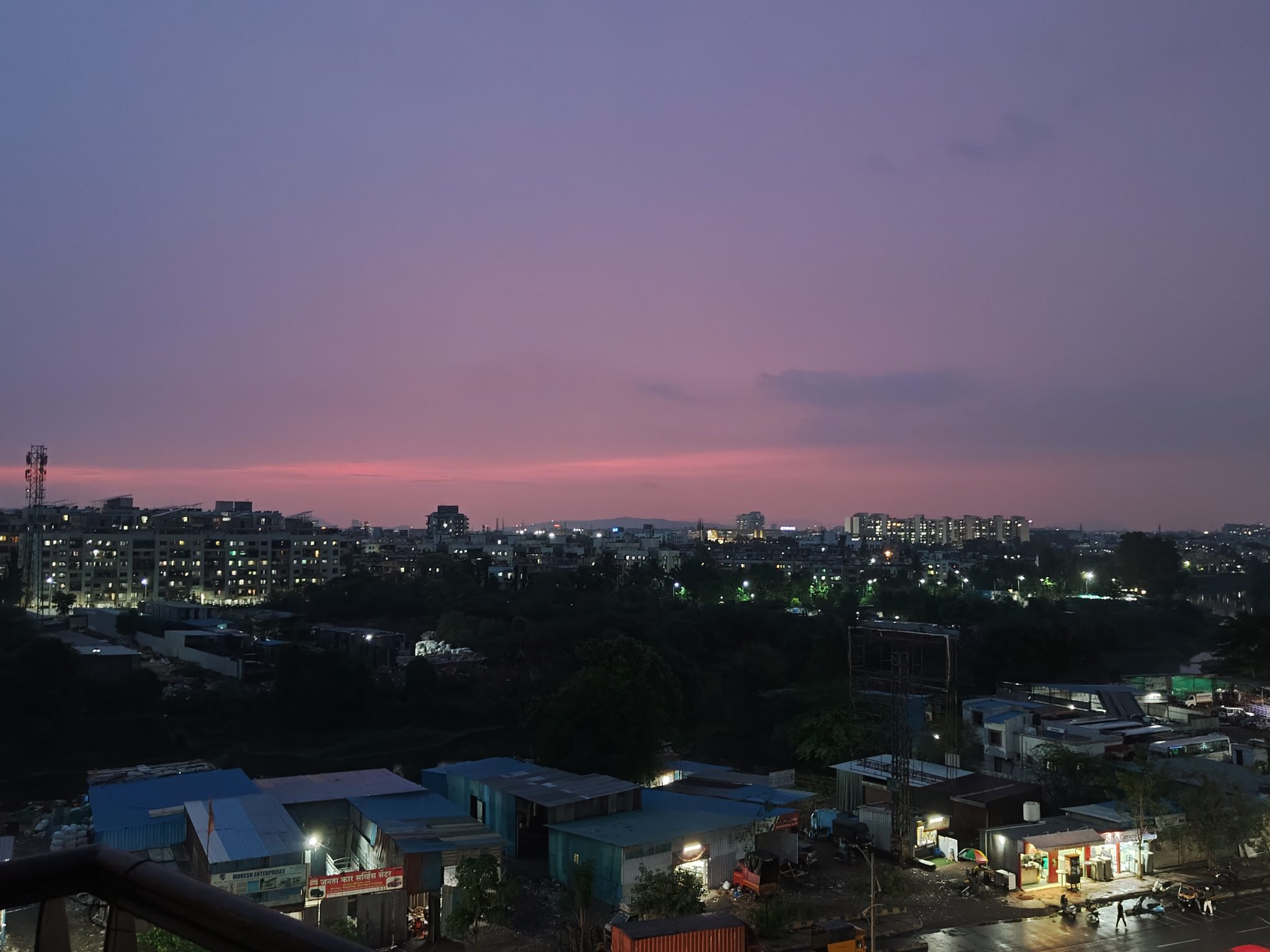 Sunset View of Pune from a balcony. Commercial buildings can be seen in the foreground, residential 