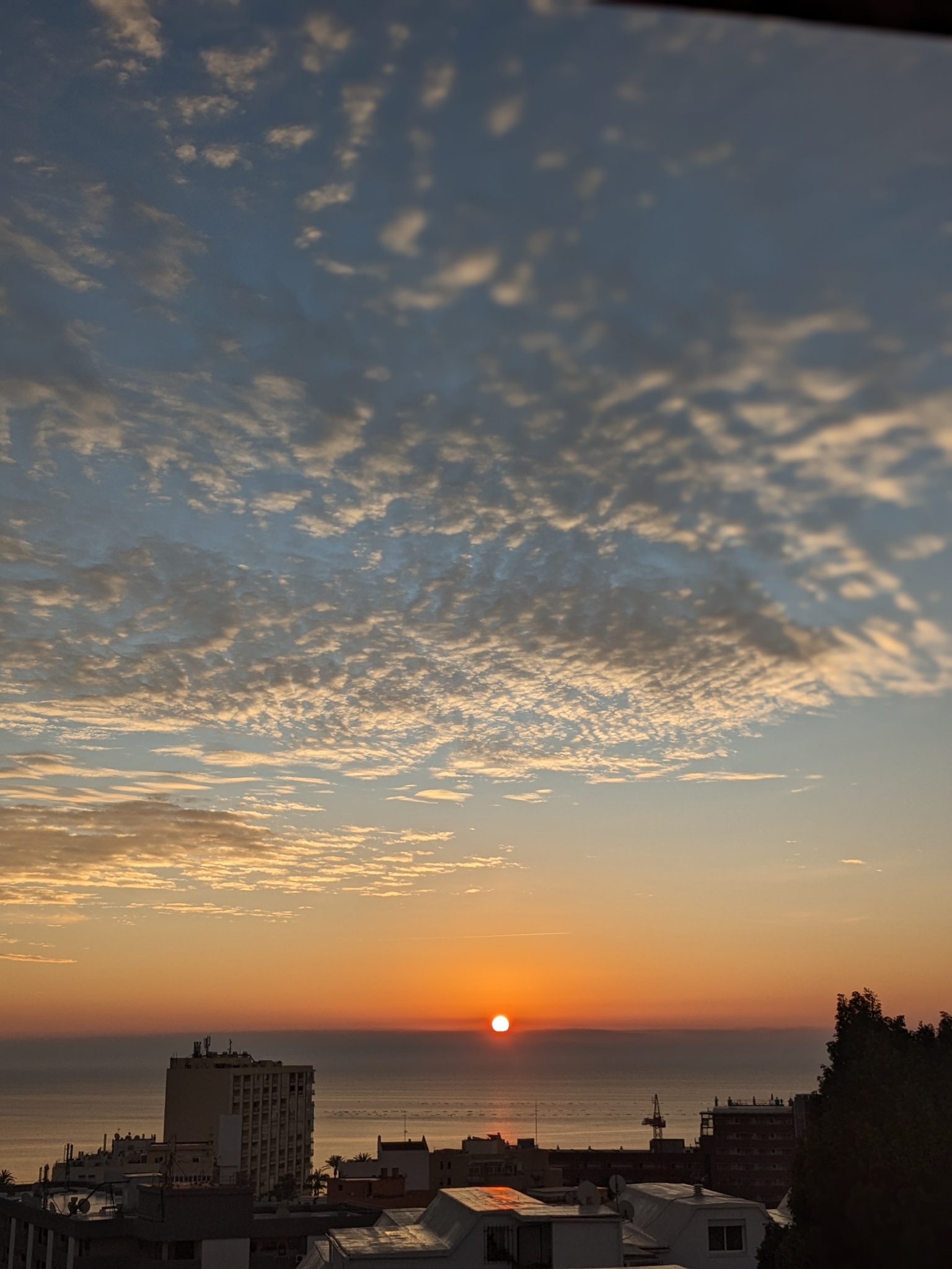 Over the rooftops Sunrise colouring clouds